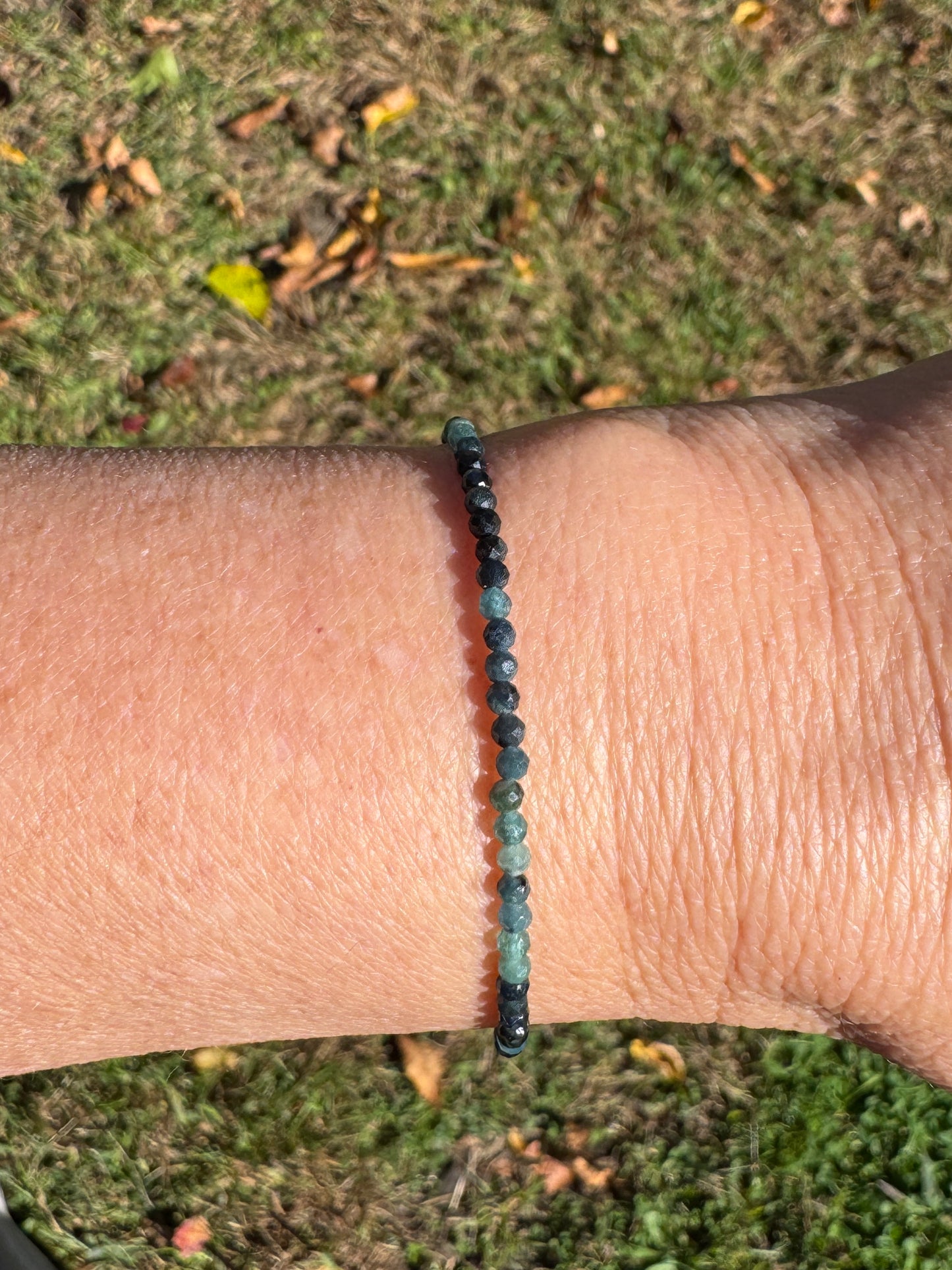 Shaded blue tourmaline beaded bracelet on wrist