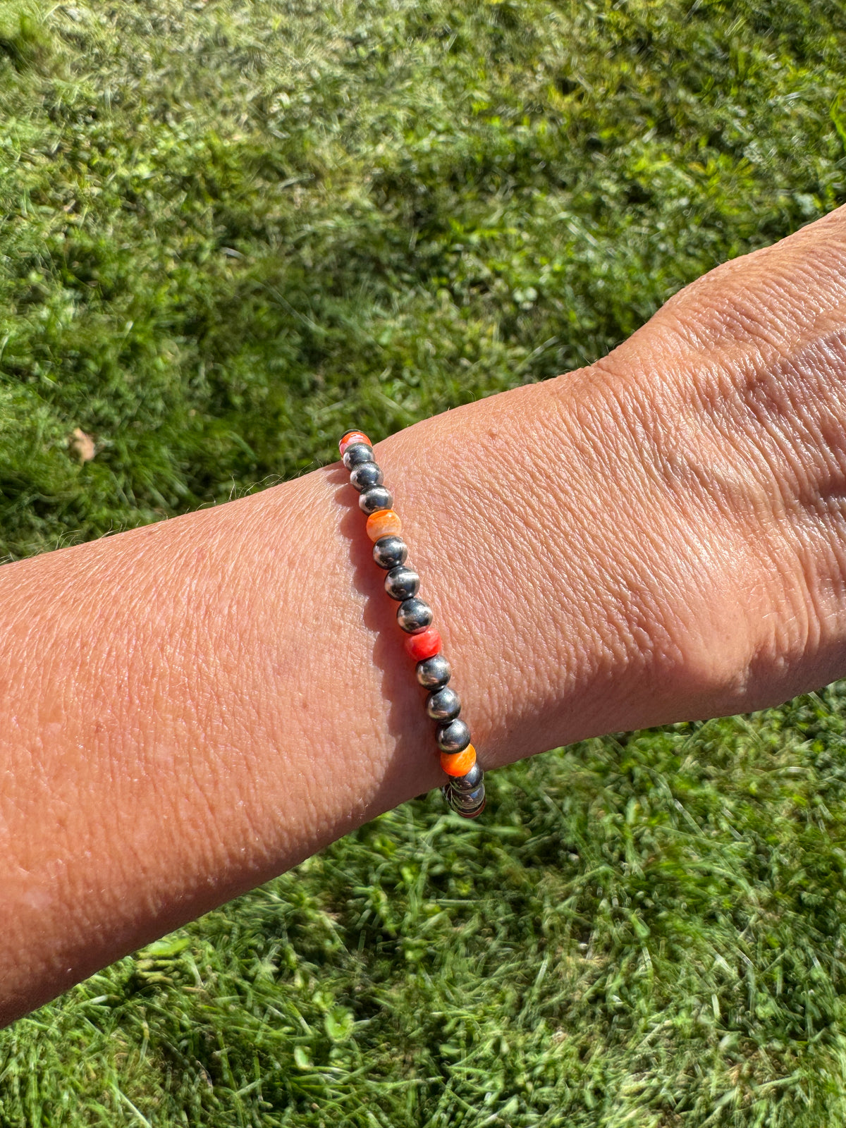 Sterling Silver Navajo Style Pearl and Spiny Oyster Bracelet on a wrist