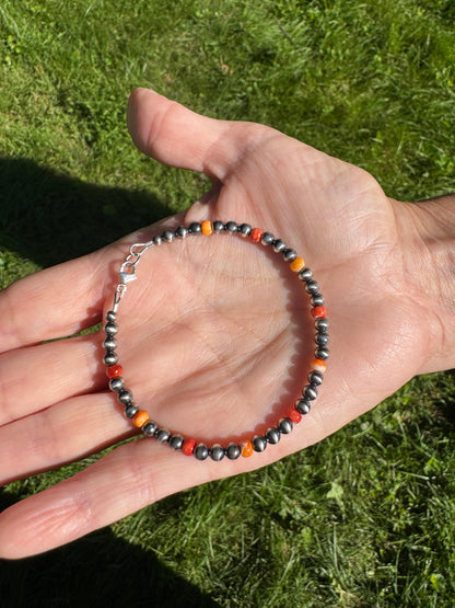 Sterling Silver Navajo Style Pearl and Spiny Oyster Bracelet in my hand